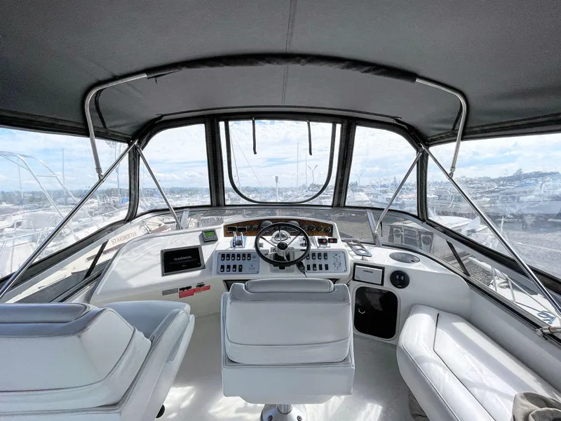 Slide: The Image of Interior view of 1995 Sea Ray 370 Sedan Bridge yacht cockpit with steering wheel and seating. - 10