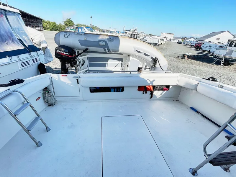 Slide: The Image of 1995 Sea Ray 370 Sedan Bridge boat deck with inflatable dinghy and ladder. - 11