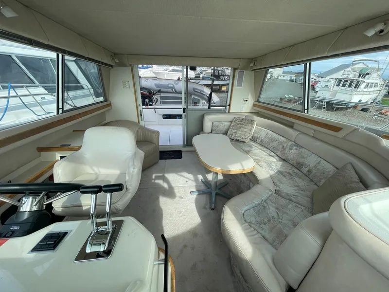 Slide: The Image of Interior of a 1995 Sea Ray 370 Sedan Bridge with plush seating and helm controls. - 4