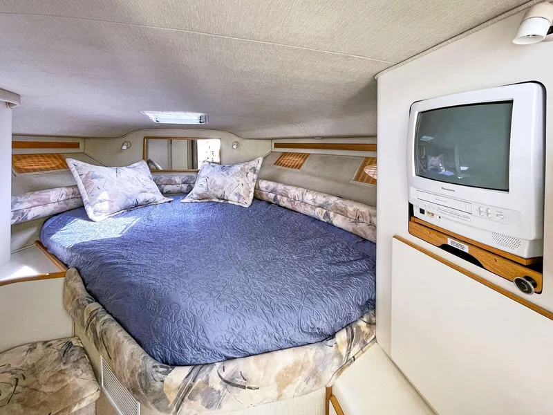 Slide: The Image of 1995 Sea Ray 370 Sedan Bridge cabin with bed and built-in TV. - 6