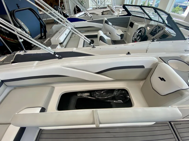 Slide: The Image of 2024 Starcraft SVX 211 Electric Blue Sport boat interior with seating and storage. - 11