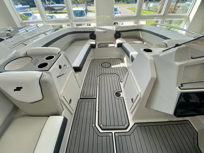 Slide: The Image of 2024 Starcraft SVX 211 Electric Blue Sport boat interior with seating and cup holders. - 16