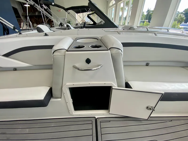 Slide: The Image of 2024 Starcraft SVX 211 Electric Blue Sport boat interior with open storage compartment. - 18