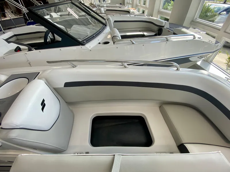 Slide: The Image of 2024 Starcraft SVX 211 Electric Blue Sport boat interior with seating and storage. - 21