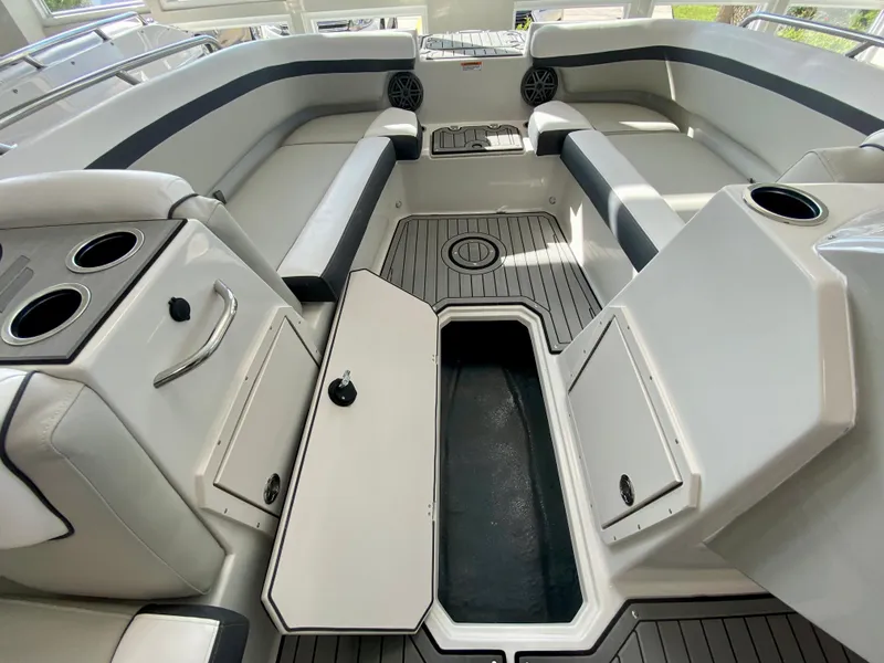 Slide: The Image of 2024 Starcraft SVX 211 Electric Blue Sport boat interior with storage compartments open. - 22