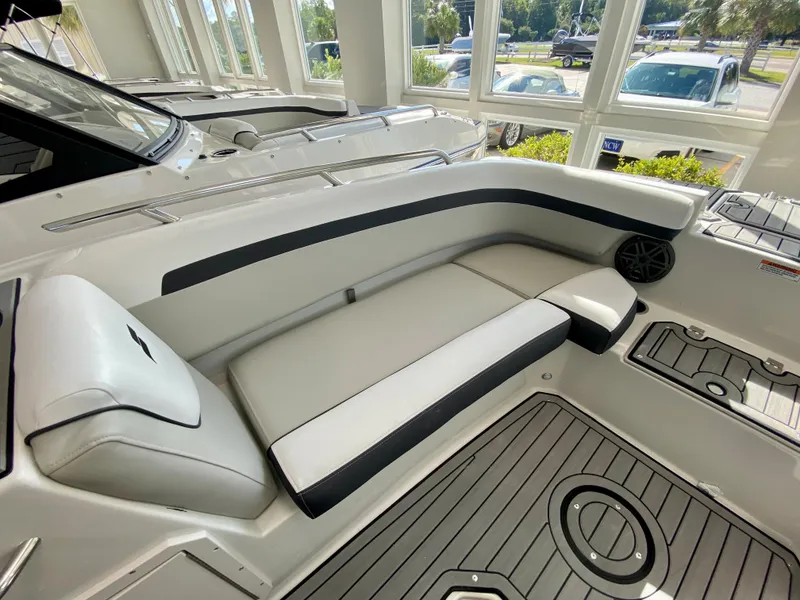 Slide: The Image of 2024 Starcraft SVX 211 Electric Blue Sport boat interior with white and black seating. - 23
