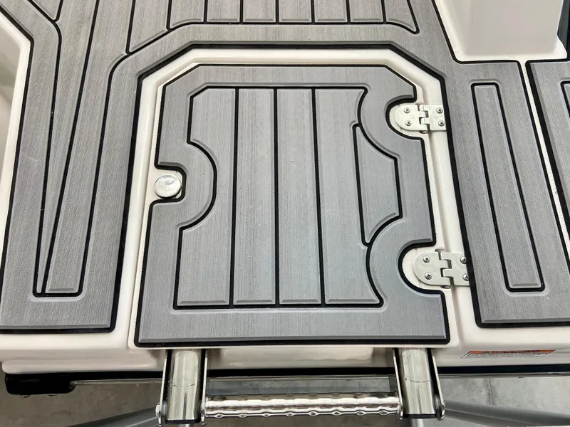 Slide: The Image of 2024 Starcraft SVX 211 Electric Blue Sport boat deck with hatch and hinges. - 5