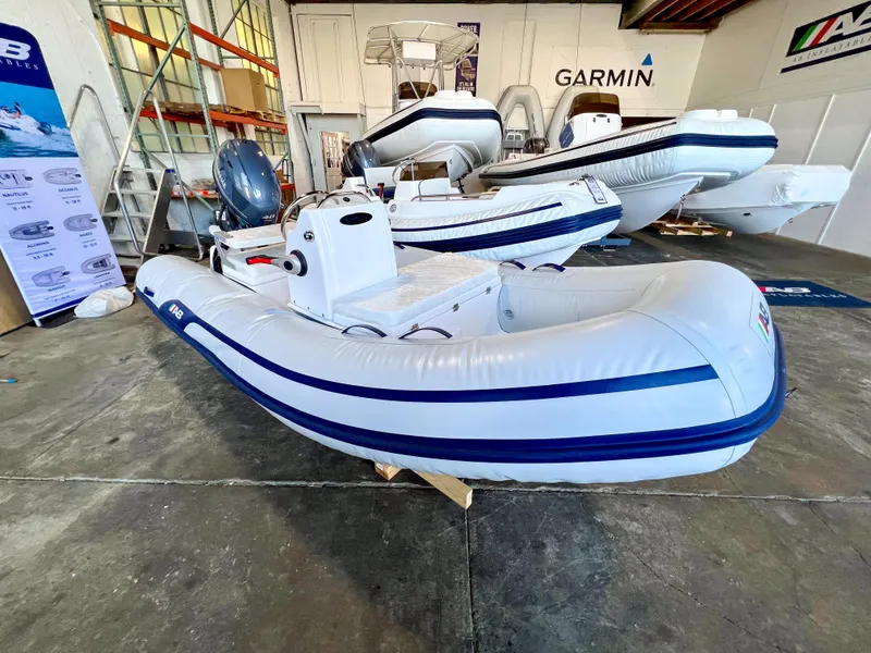 Slide: The Image of 2024 AB Inflatables Mares 12 VSX boat in stock, displayed in a showroom. - 3