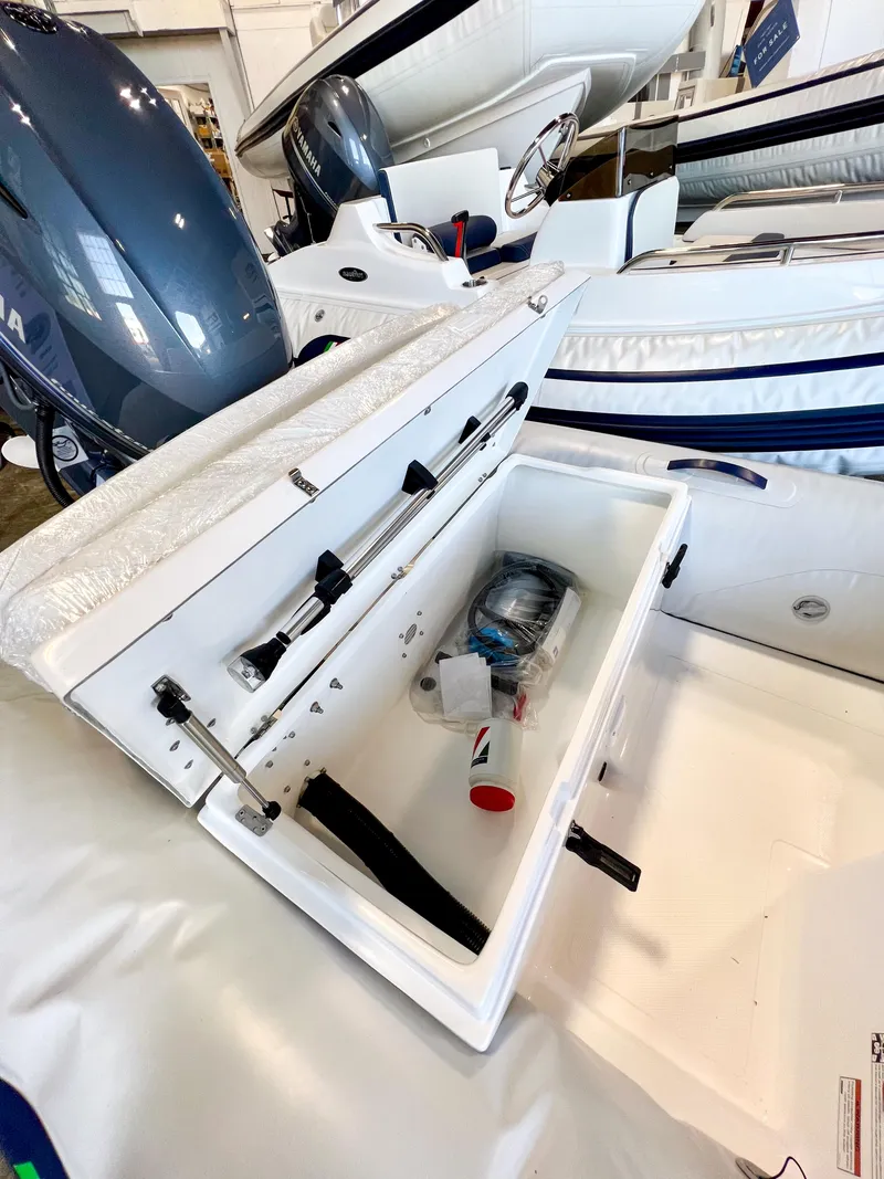 Slide: The Image of 2024 AB Inflatables Mares 12 VSX boat storage compartment with Yamaha outboard motor. - 7