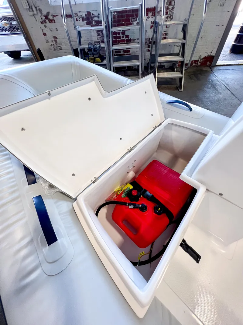 Slide: The Image of 2024 AB Inflatables Mares 12 VSX storage compartment with red fuel tank. - 9