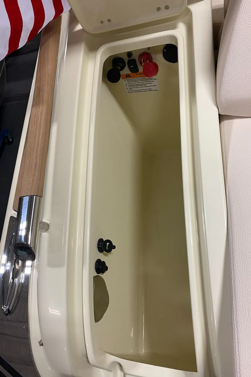 Slide: The Image of 2025 Chris-Craft Launch 28 GT boat interior with beige seating and American flag detail. - 24