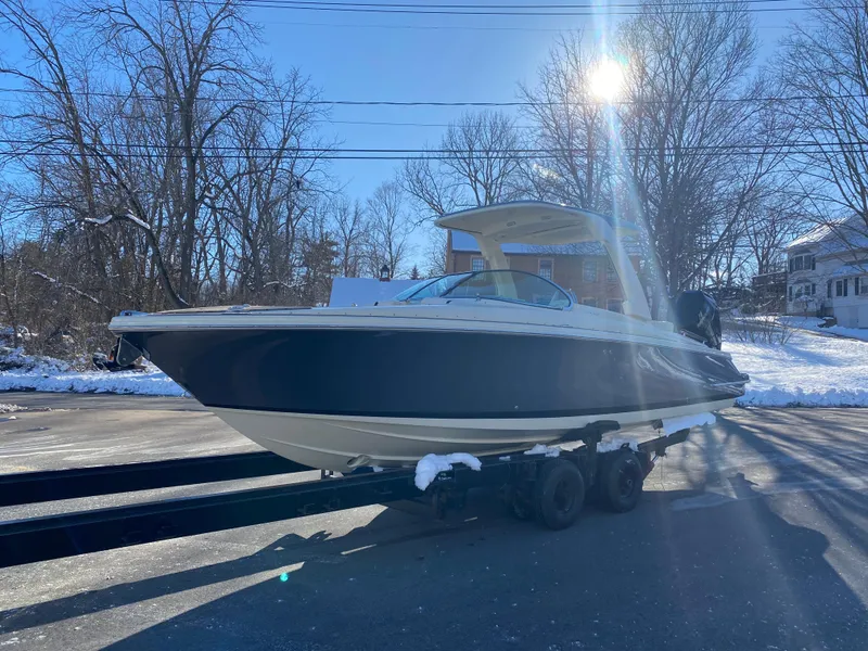 Slide: The Image of 2025 Chris-Craft Launch 28 GT boat on trailer in snowy outdoor setting. - 4