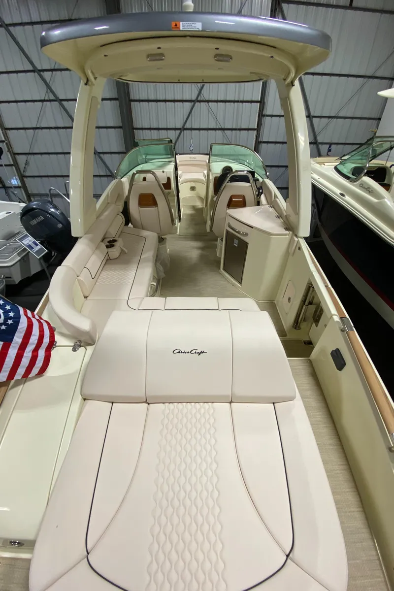 Slide: The Image of 2025 Chris-Craft Launch 28 GT boat on trailer, parked outdoors in winter setting. - 6