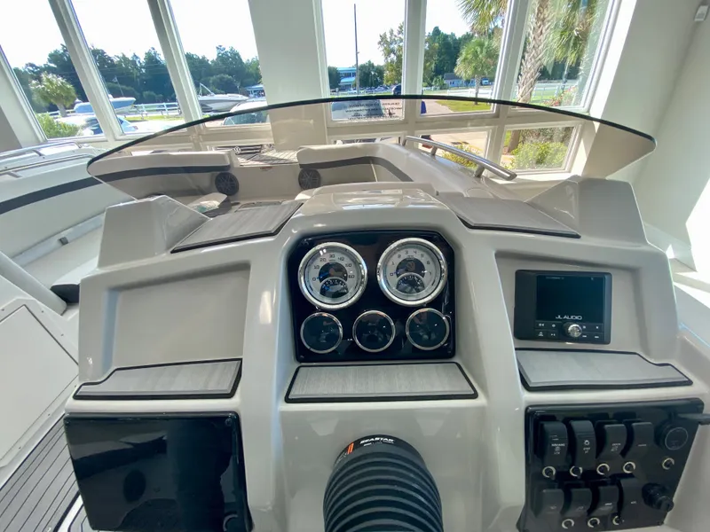 Slide: The Image of 2024 Starcraft SVX 211 Electric Blue Sport boat dashboard with gauges and controls. - 14