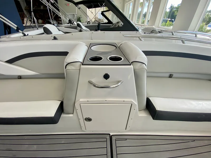 Slide: The Image of 2024 Starcraft SVX 211 Electric Blue Sport boat interior with cup holders and seating. - 17