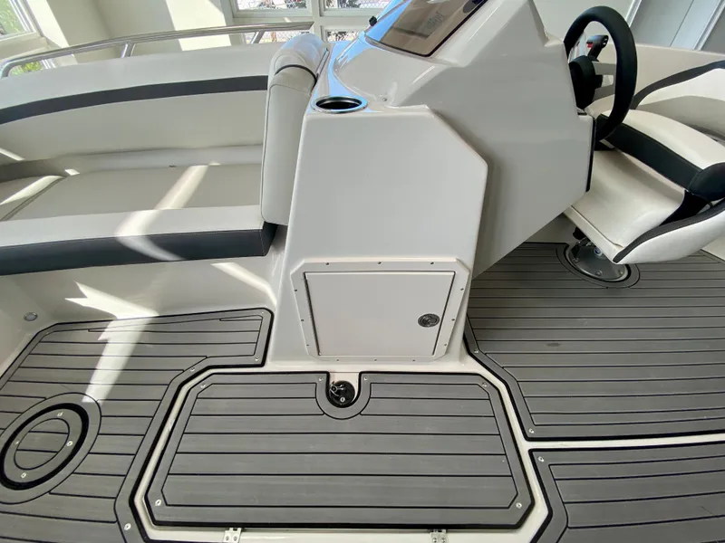 Slide: The Image of 2024 Starcraft SVX 211 Electric Blue Sport boat interior with modern seating and flooring. - 19