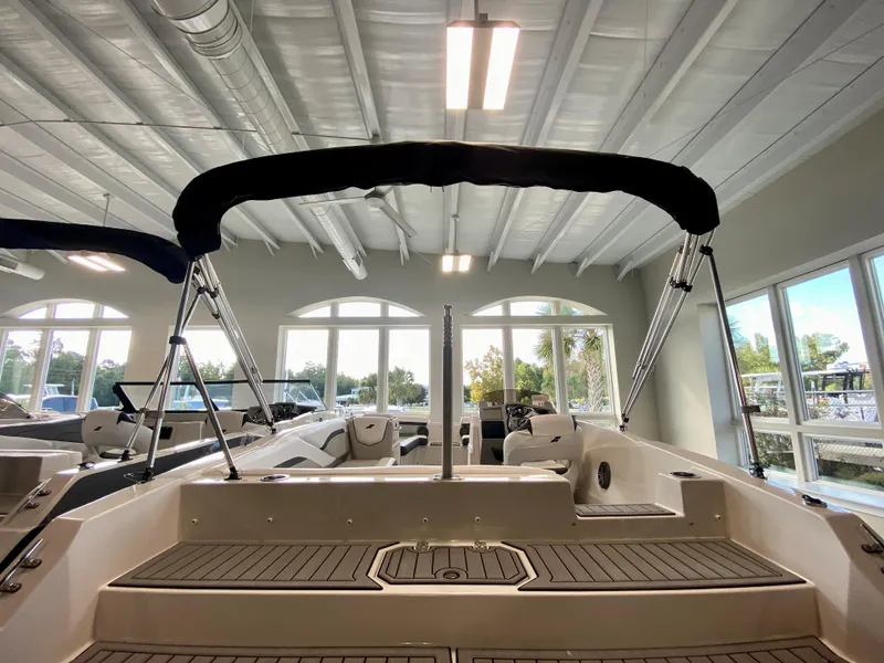 Slide: The Image of 2024 Starcraft SVX 211 Electric Blue Sport boat interior in showroom. - 2