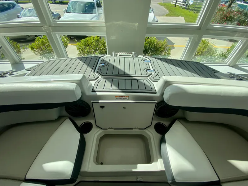 Slide: The Image of Interior of 2024 Starcraft SVX 211 Electric Blue Sport boat with seating and storage. - 25