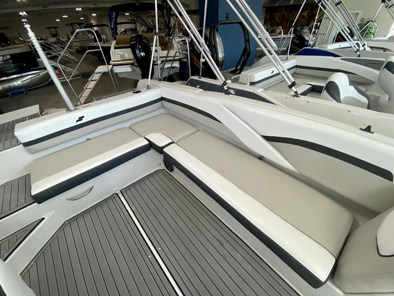 Slide: The Image of 2024 Starcraft SVX 211 Electric Blue Sport boat interior with white and gray seating. - 9