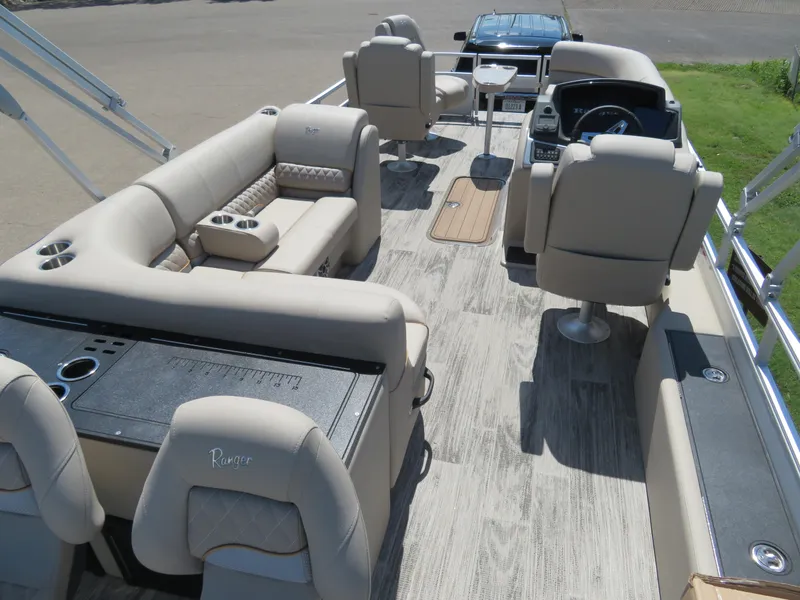 Slide: The Image of 2024 Ranger 223FC pontoon boat interior with beige seating and modern amenities. - 11
