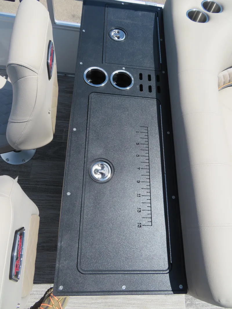 Slide: The Image of 2024 Ranger 223FC boat console with cup holders and storage compartments. - 12