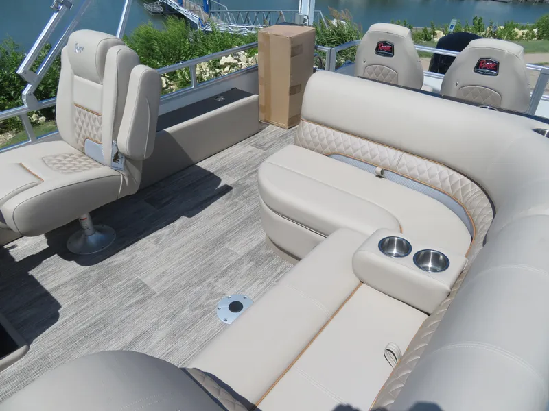 Slide: The Image of 2024 Ranger 223FC boat interior with beige seating and cup holders. - 13