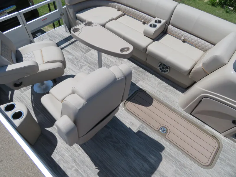Slide: The Image of 2024 Ranger 223FC boat interior with beige seating and wood-like flooring. - 14