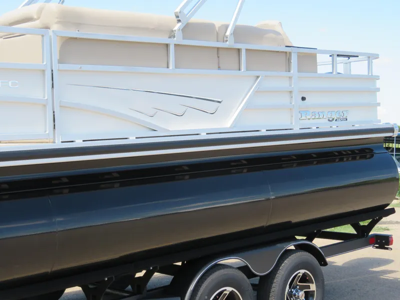 Slide: The Image of 2024 Ranger 223FC pontoon boat on a trailer, side view. - 2
