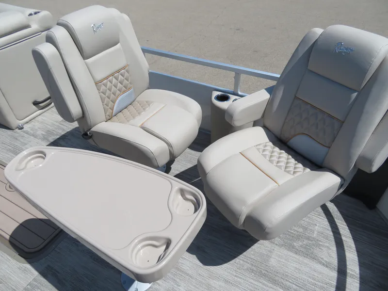 Slide: The Image of 2024 Ranger 223FC boat with beige leather seats and a table. - 5
