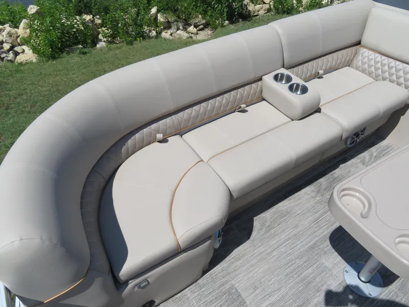 Slide: The Image of 2024 Ranger 223FC boat with beige cushioned seating and cup holders. - 6