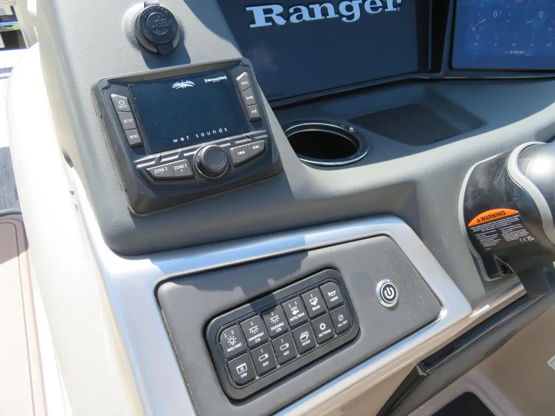 Slide: The Image of 2024 Ranger 223FC boat dashboard with control panel and audio system. - 7