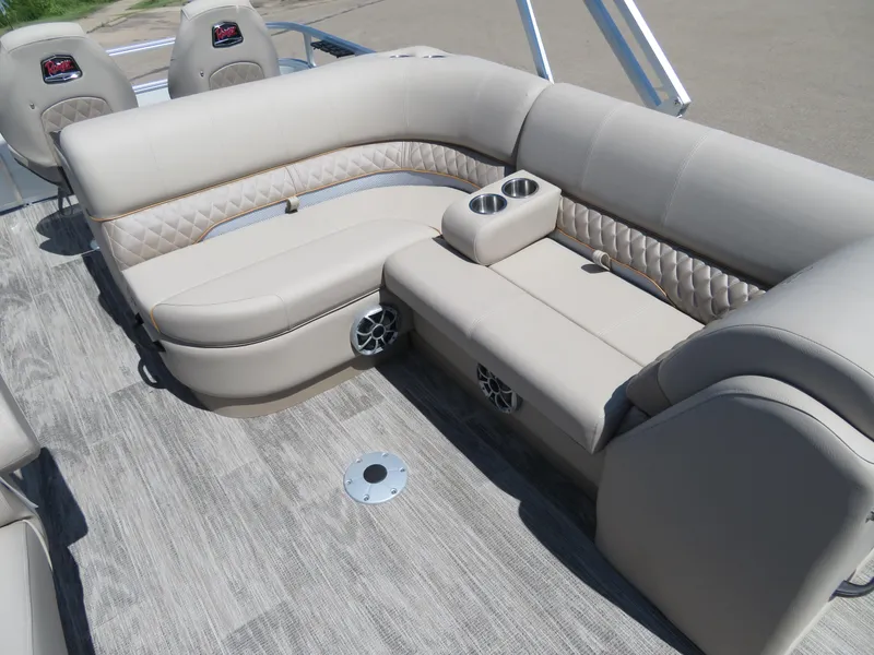 Slide: The Image of 2024 Ranger 223FC boat interior with beige seating and cup holders. - 9