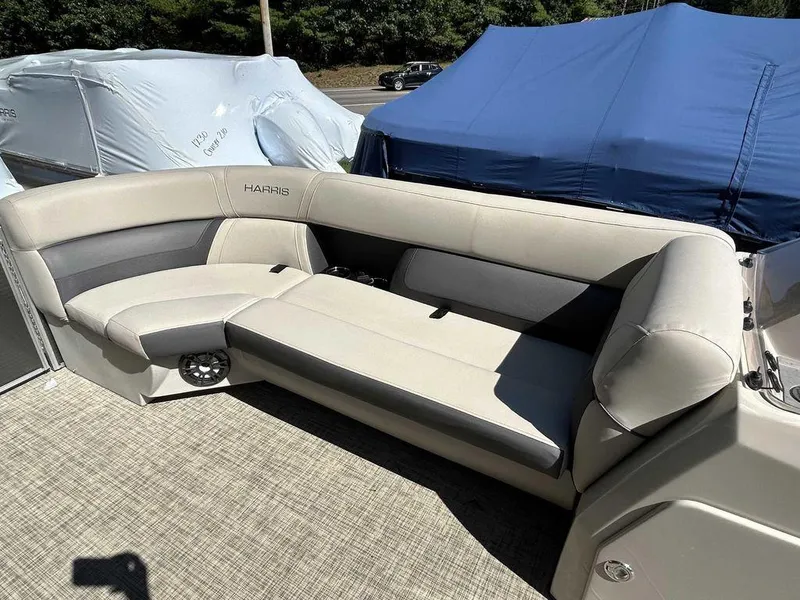 Slide: The Image of 2021 Harris Cruiser 250 boat interior with beige seating. - 10