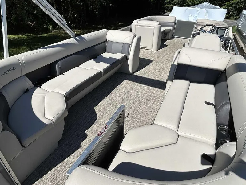 Slide: The Image of 2021 Harris Cruiser 250 pontoon boat with spacious seating and modern interior. - 14
