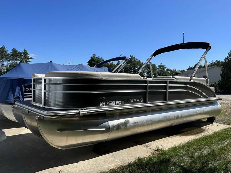 Slide: The Image of 2021 Harris Cruiser 250 pontoon boat with canopy on a sunny day. - 3