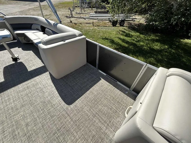 Slide: The Image of 2021 Harris Cruiser 250 pontoon boat interior with spacious seating and carpeted deck. - 9
