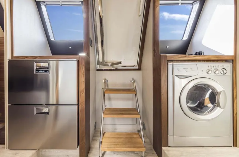 Slide: The Image of Laundry area in 2024 Absolute 68 NAVETTA yacht with washer, dryer, and wooden steps. - 21