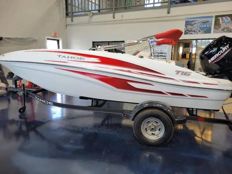 Slide: The Image of 2024 Tahoe T16 boat with red and white design on trailer in showroom. - 5