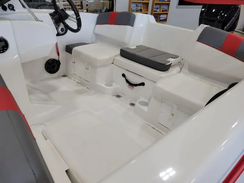 Slide: The Image of 2024 Tahoe T16 boat interior with white and red seating, storage compartments, and steering wheel. - 7