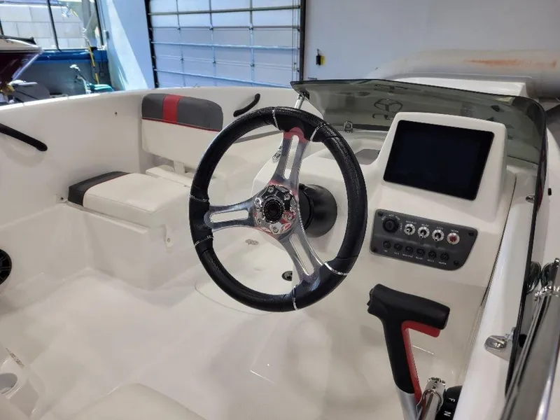 Slide: The Image of 2024 Tahoe T16 boat cockpit with steering wheel and control panel. - 9