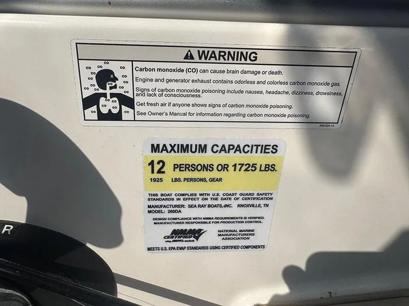Slide: The Image of Warning and capacity labels on 2015 Sea Ray 260 Sundancer boat. - 15