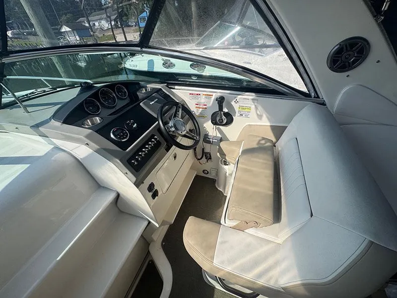 Slide: The Image of Interior of 2015 Sea Ray 260 Sundancer boat, featuring helm and seating area. - 17