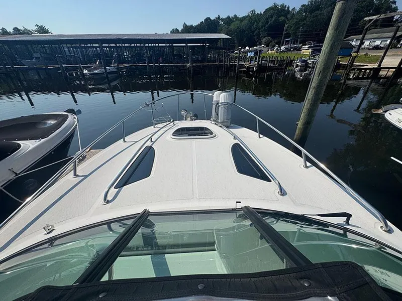 Slide: The Image of 2015 Sea Ray 260 Sundancer docked at marina, view from bow. - 20