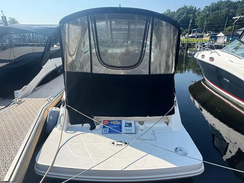 Slide: The Image of 2015 Sea Ray 260 Sundancer boat docked with cover, for sale sign visible. - 4
