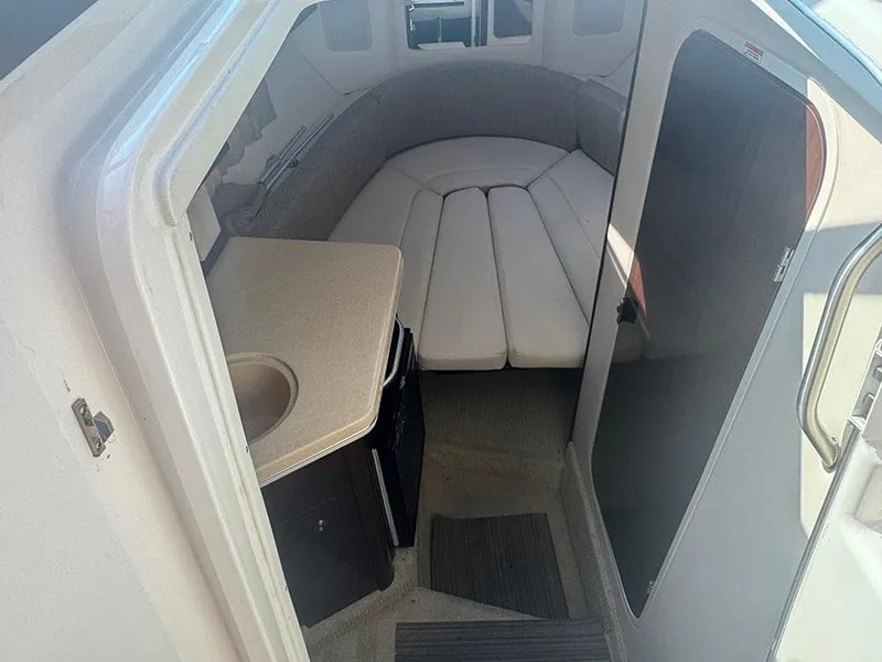 Slide: The Image of 2015 Sea Ray 260 Sundancer cabin interior with seating and kitchenette. - 5