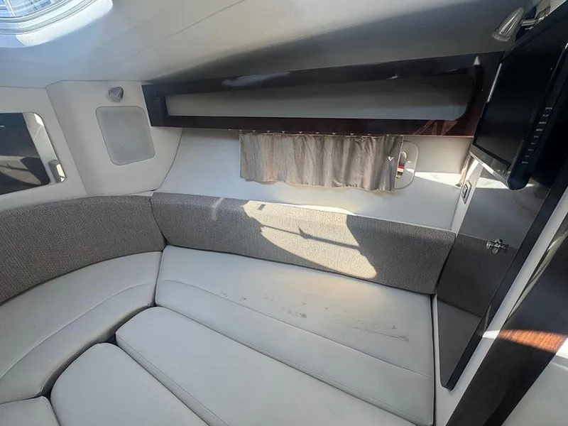 Slide: The Image of Interior of 2015 Sea Ray 260 Sundancer boat with cushioned seating and storage. - 7