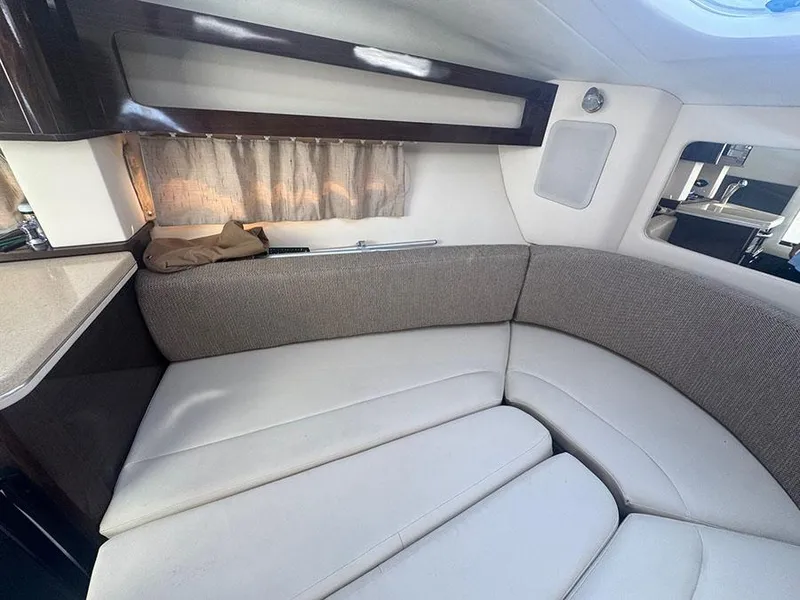 Slide: The Image of Interior cabin of 2015 Sea Ray 260 Sundancer with cushioned seating and window. - 8