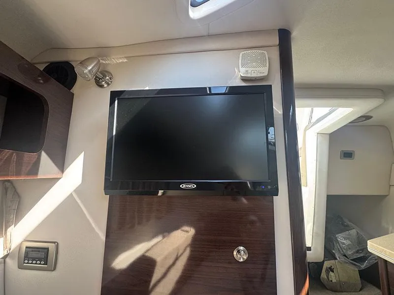 Slide: The Image of Interior of 2015 Sea Ray 260 Sundancer with mounted TV and speaker. - 9