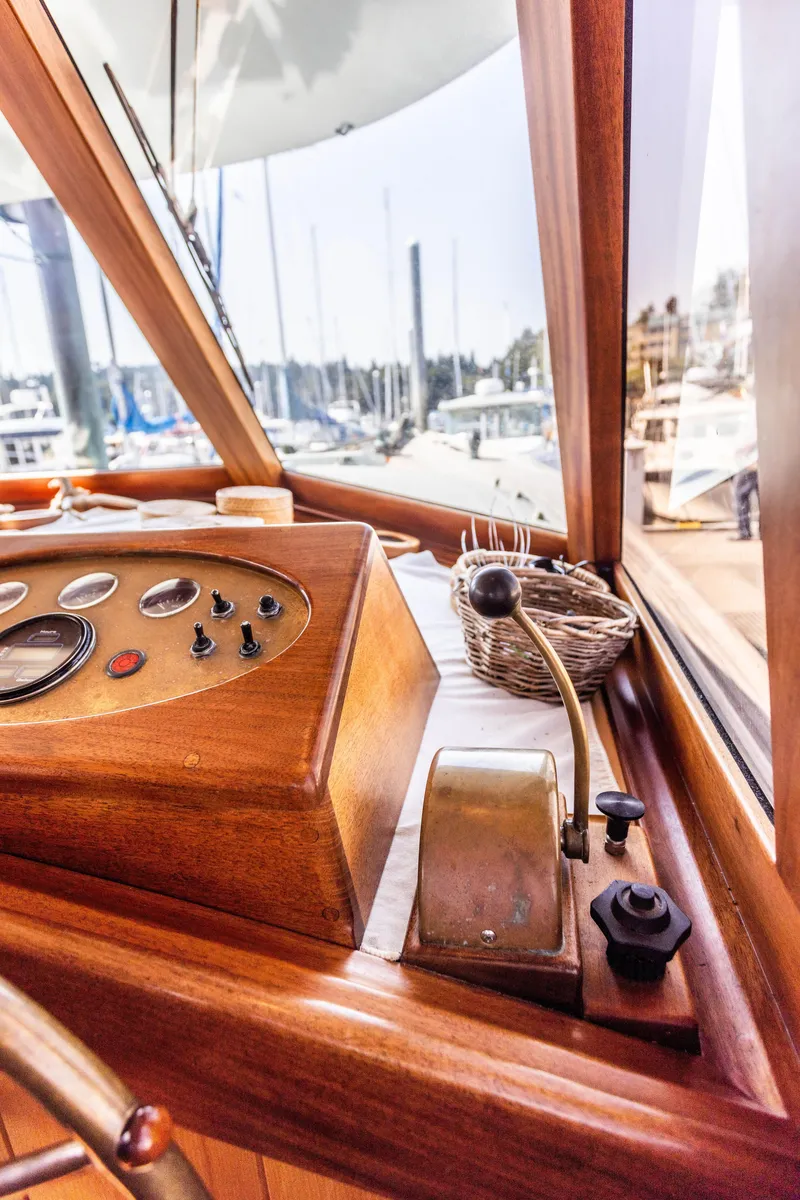 Slide: The Image of 2009 Custom Gartside Downeast Cruiser helm with wooden dashboard and marina view. - 11