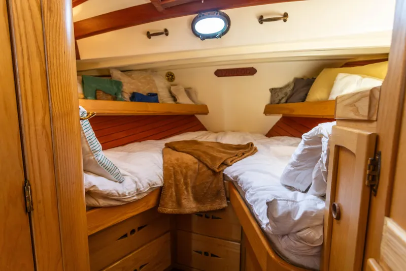 Slide: The Image of Cozy cabin interior of 2009 Custom Gartside Downeast Cruiser with wooden furnishings and bedding. - 13
